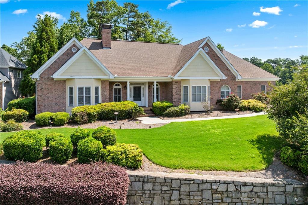 2012 Arbor Springs Way Buford, GA 30519 - Photo 2 of 61 a front view of a house with a yard and potted plants