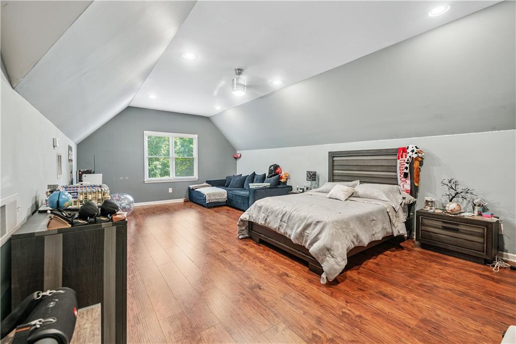 2012 Arbor Springs Way Buford, GA 30519 - Photo 28 of 61 a spacious bedroom with a bed and wooden floor
