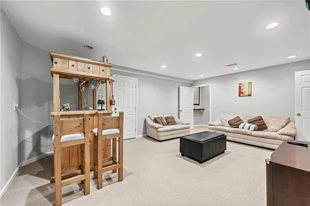 a front view of a house with a yard and trees