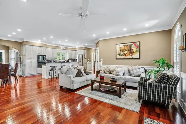 a kitchen with lots of counter top space appliances and wooden floor