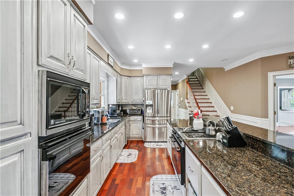 2012 Arbor Springs Way Buford, GA 30519 - Photo 8 of 61 a kitchen with lots of counter top space appliances and wooden floor