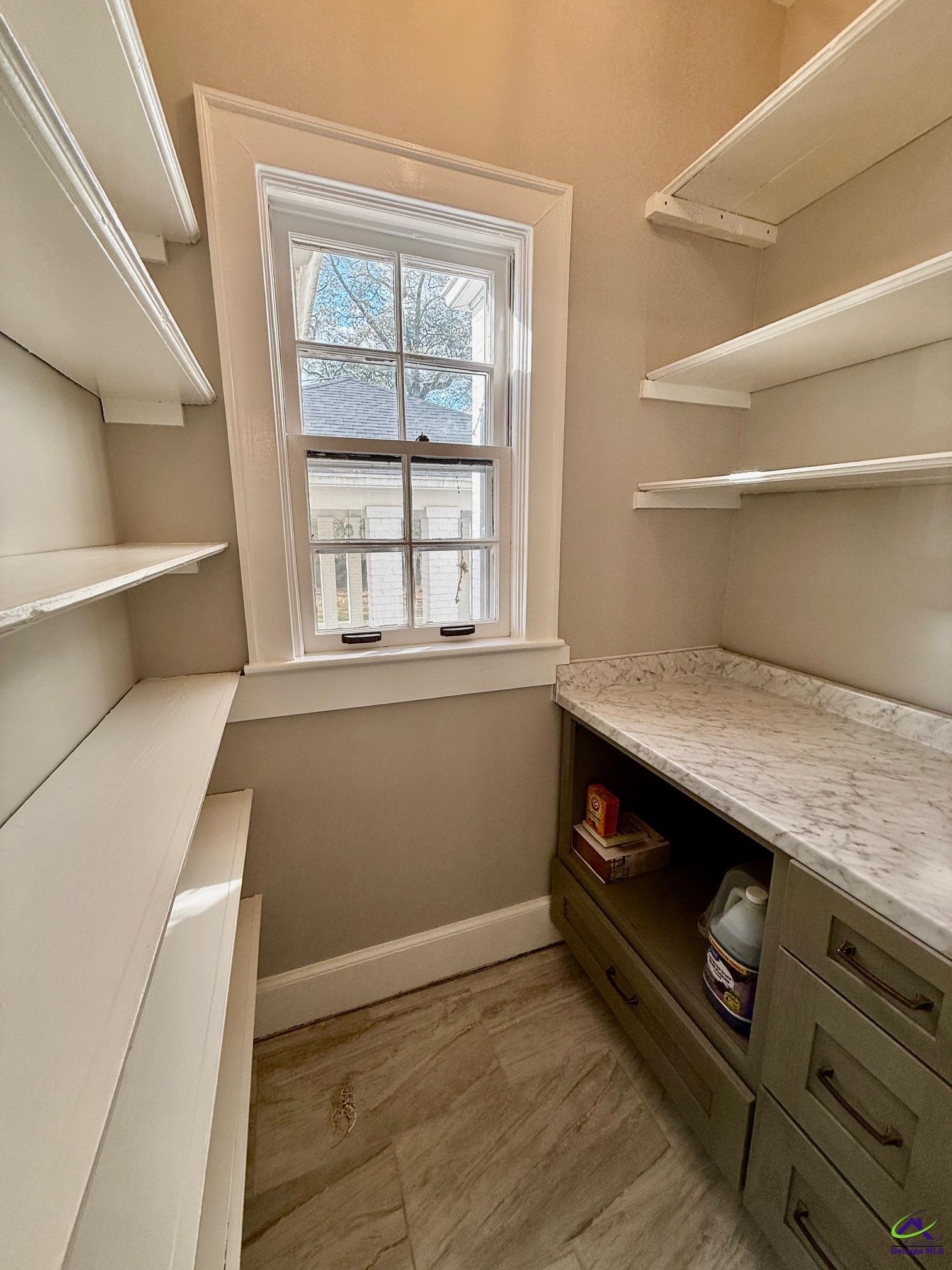 515 Engram Street Montezuma, GA 31063 - Photo 13 of 35 a view of an empty room with wooden floor and a window