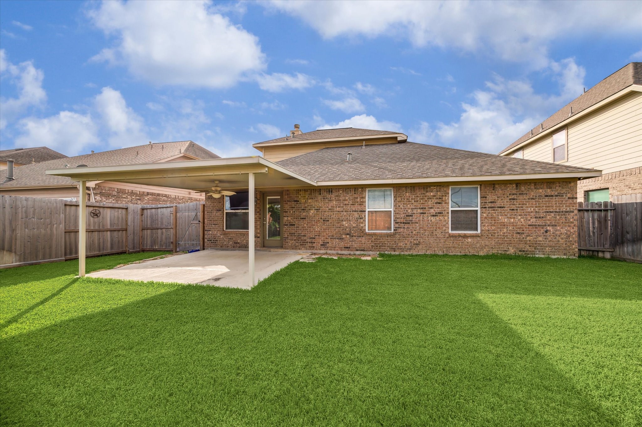 9015 Springcroft Court Tomball, TX 77375 - Photo 33 of 35 a view of a backyard with table and chairs and wooden fence
