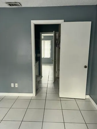 a view of a hallway to rooms