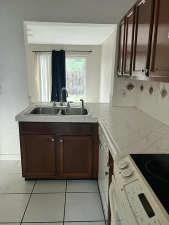 a bathroom with a granite countertop sink a mirror and vanity