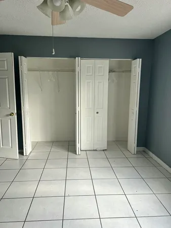 a view of a livingroom with an empty space and a window