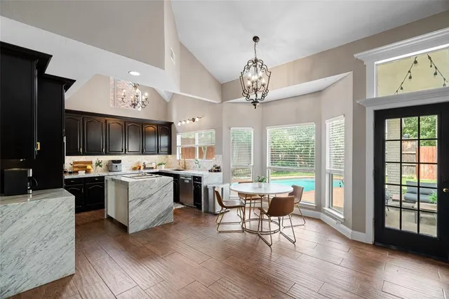 a living room with kitchen island furniture and a chandelier
