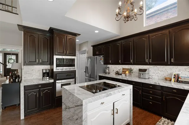 a kitchen with a sink and stainless steel appliances