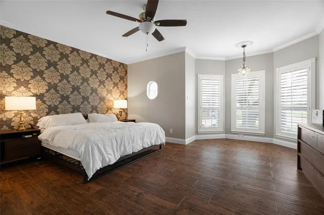 a bedroom with a large bed and a large window