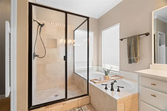 a bathroom with a tub sink and mirror