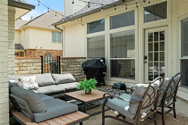 a view of a patio with couches chairs and wooden floor