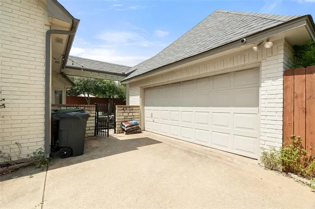 a backyard of a house with barbeque oven table and chairs