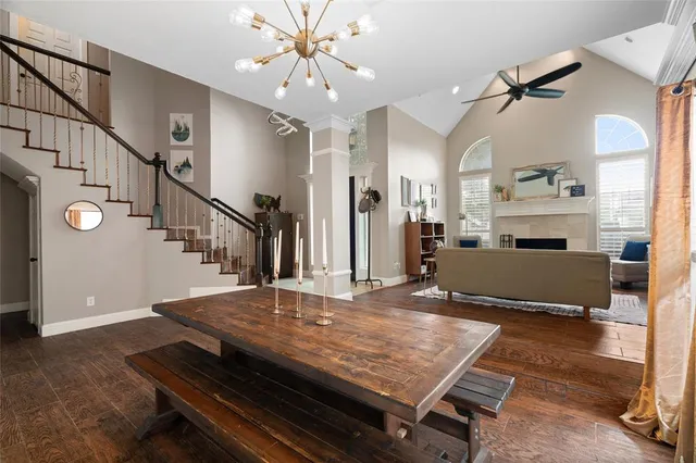 a living room with wooden floor and pool table