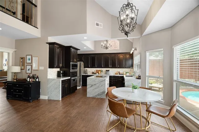 a kitchen that has a table chairs and a stove