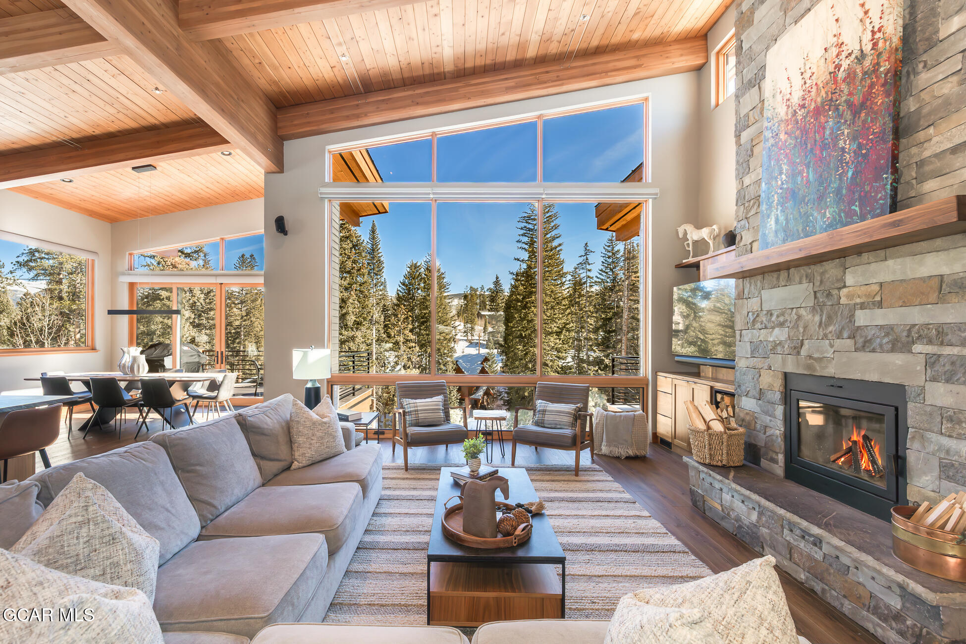 684 Vasquez Road Winter Park, CO 80482 - Photo 4 of 45 a living room with furniture a fireplace and large windows