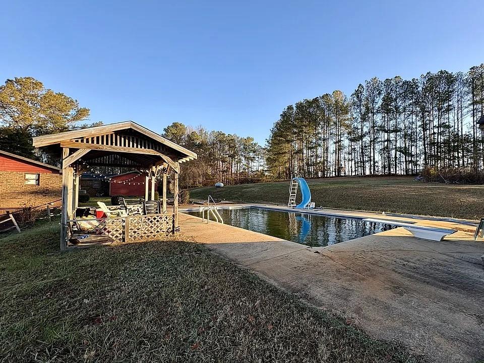 781 Thomas Street Roopville, GA 30170 - Photo 12 of 14 a view of a swimming pool with an outdoor seating