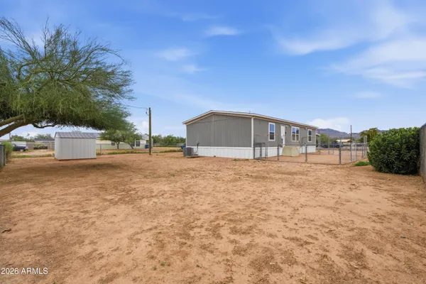 a living room with furniture and view of kitchen