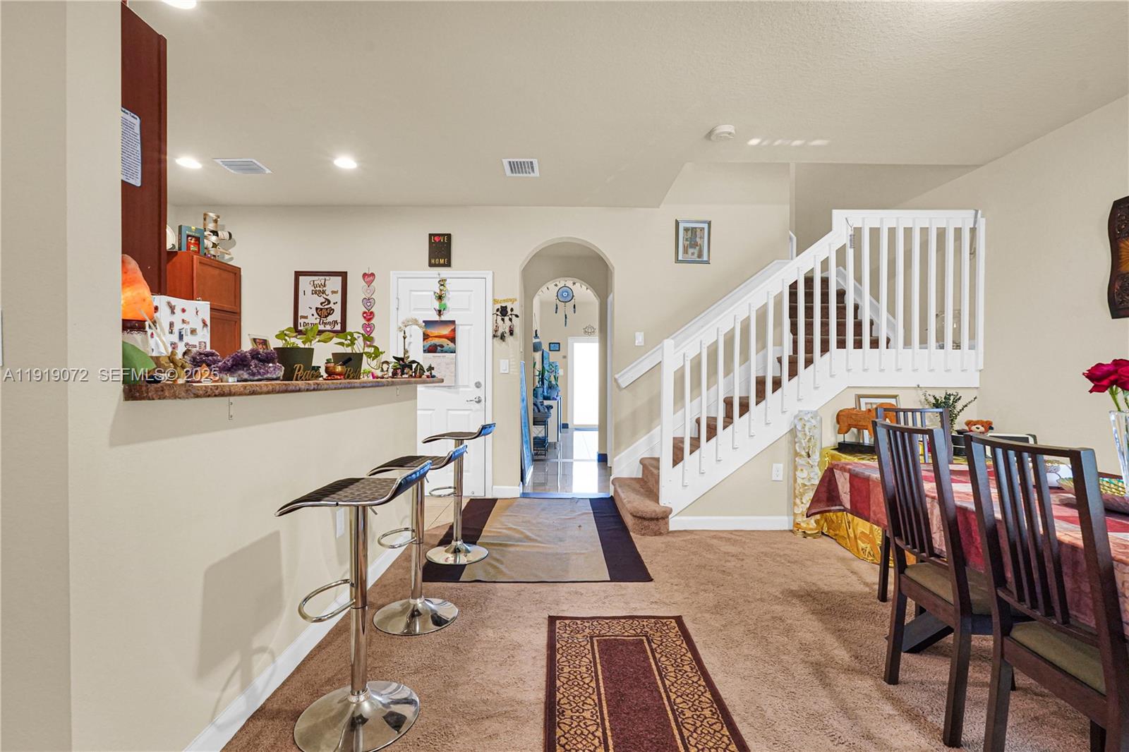 a view of front door with dining room and stairs