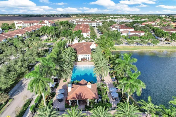 an aerial view of residential houses with outdoor space and street view