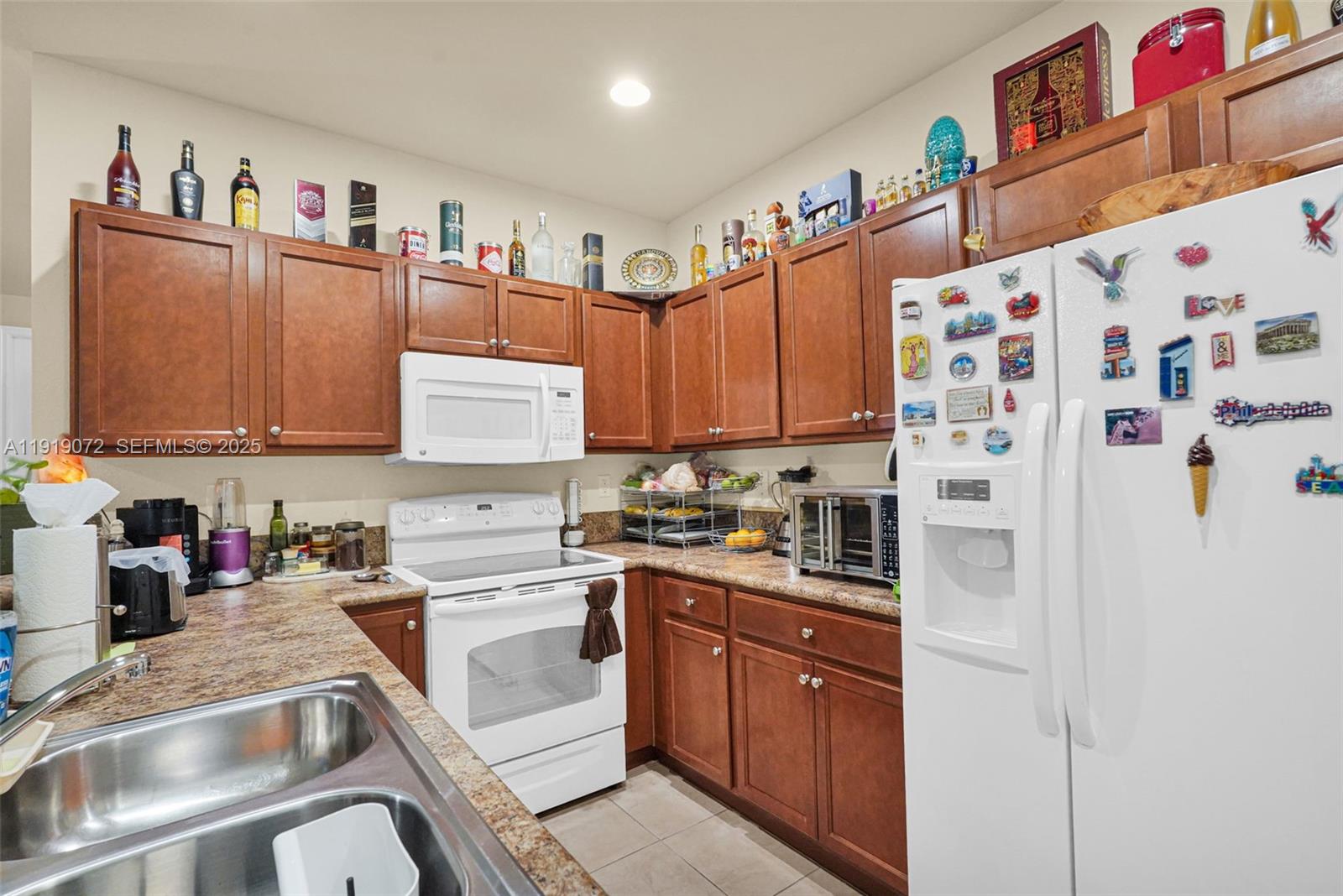 9213 Southwest 170th Avenue Miami, FL 33196 - Photo 35 of 82 a kitchen with stainless steel appliances granite countertop a refrigerator and a sink