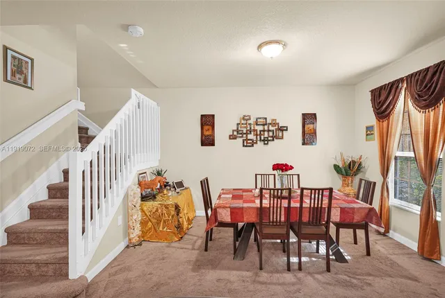 a view of a hallway with wooden floor and a bathroom