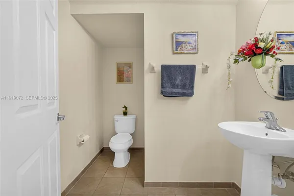 a view of a room with wooden floor and a hallway