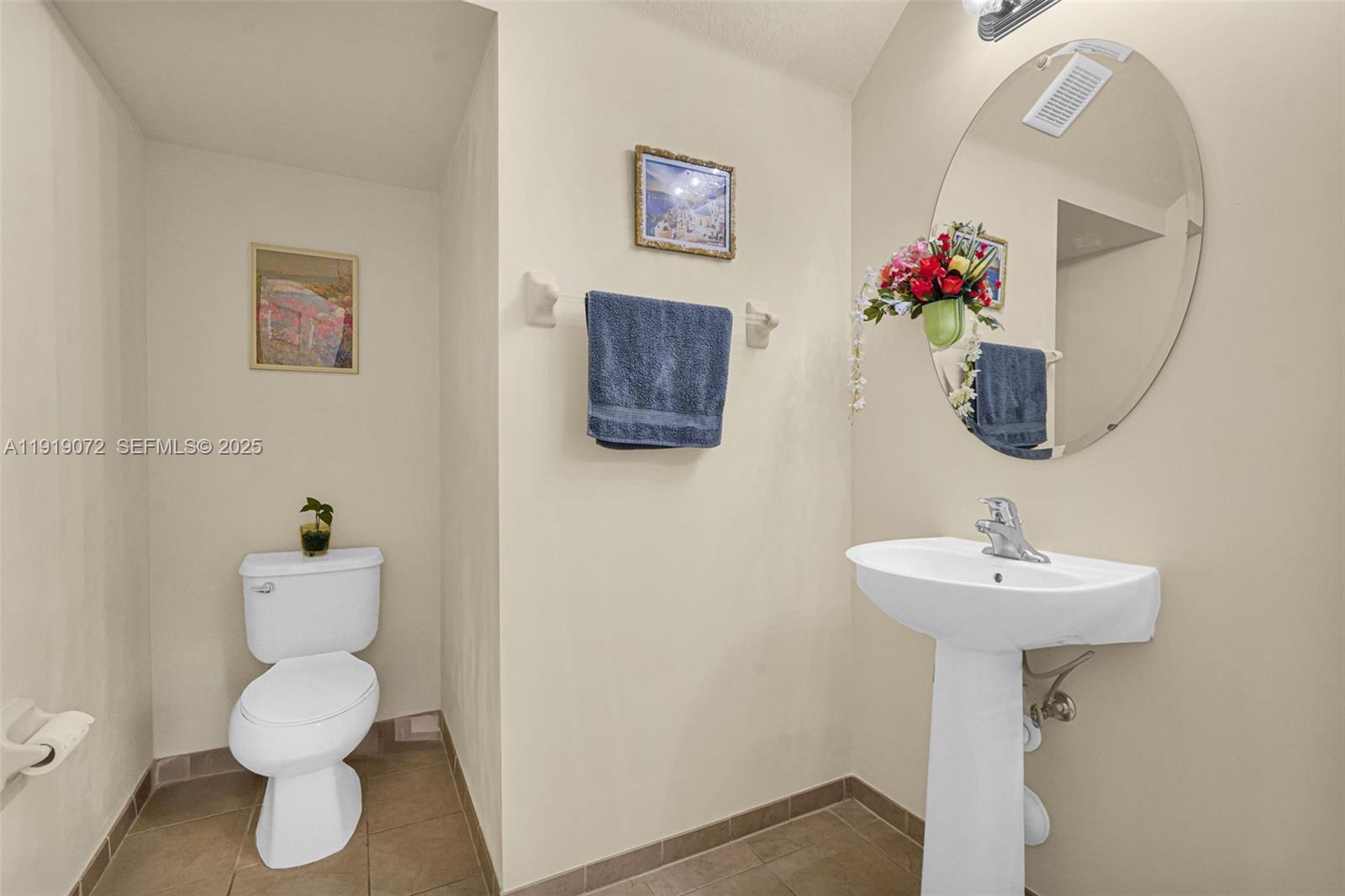 9213 Southwest 170th Avenue Miami, FL 33196 - Photo 37 of 82 a bathroom with a sink mirror and toilet