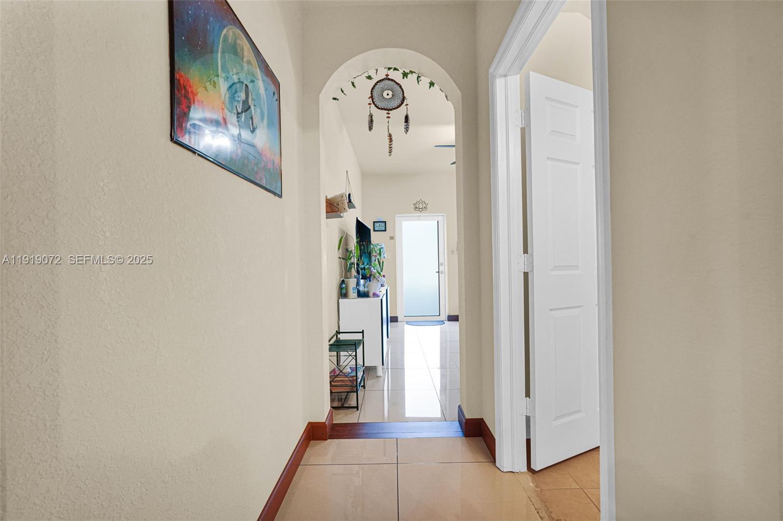 9213 Southwest 170th Avenue Miami, FL 33196 - Photo 38 of 82 a view of a hallway with wooden floor and a dining room