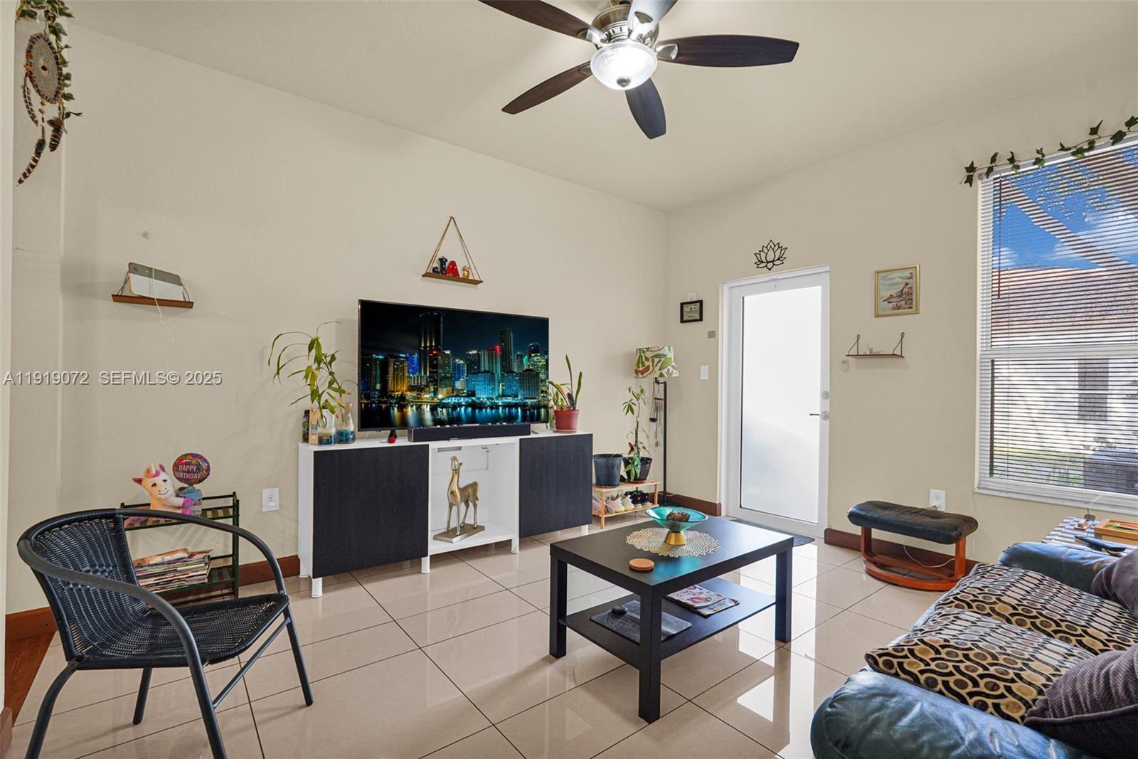 9213 Southwest 170th Avenue Miami, FL 33196 - Photo 40 of 82 a living room with furniture and a chandelier
