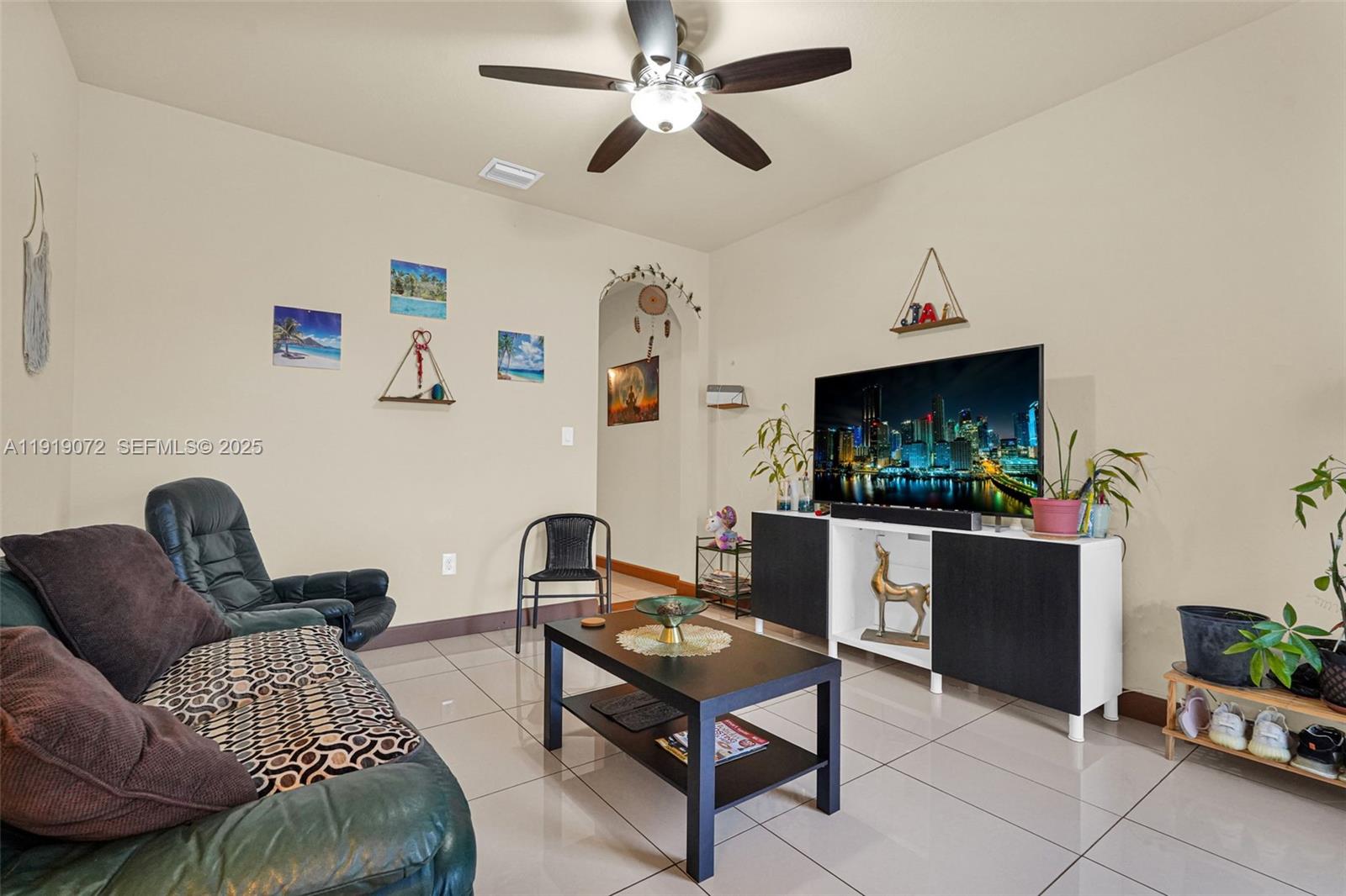 9213 Southwest 170th Avenue Miami, FL 33196 - Photo 41 of 82 a living room with furniture and a flat screen tv