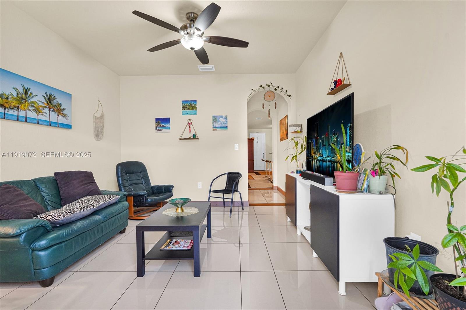 9213 Southwest 170th Avenue Miami, FL 33196 - Photo 42 of 82 a living room with furniture and a flat screen tv