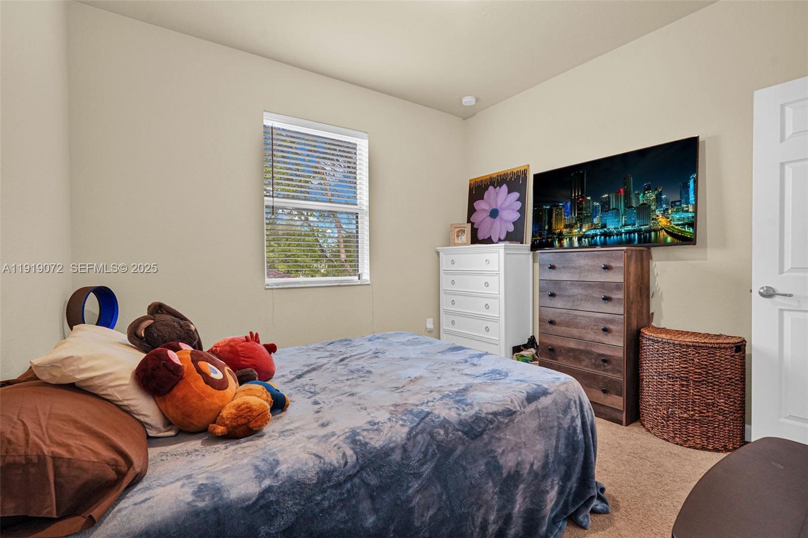 9213 Southwest 170th Avenue Miami, FL 33196 - Photo 47 of 82 a bedroom with a bed and flat screen tv