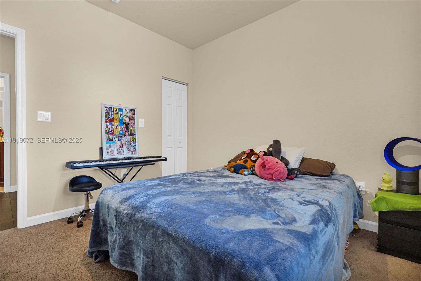 9213 Southwest 170th Avenue Miami, FL 33196 - Photo 48 of 82 a bedroom with a bed and a painting on the wall