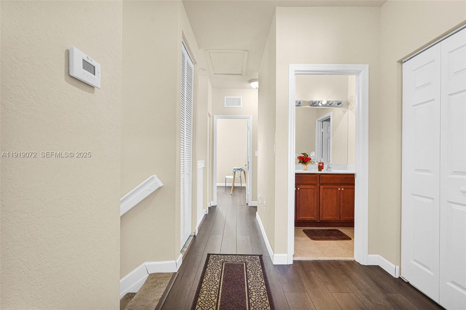9213 Southwest 170th Avenue Miami, FL 33196 - Photo 49 of 82 a view of a hallway with wooden floor and closet