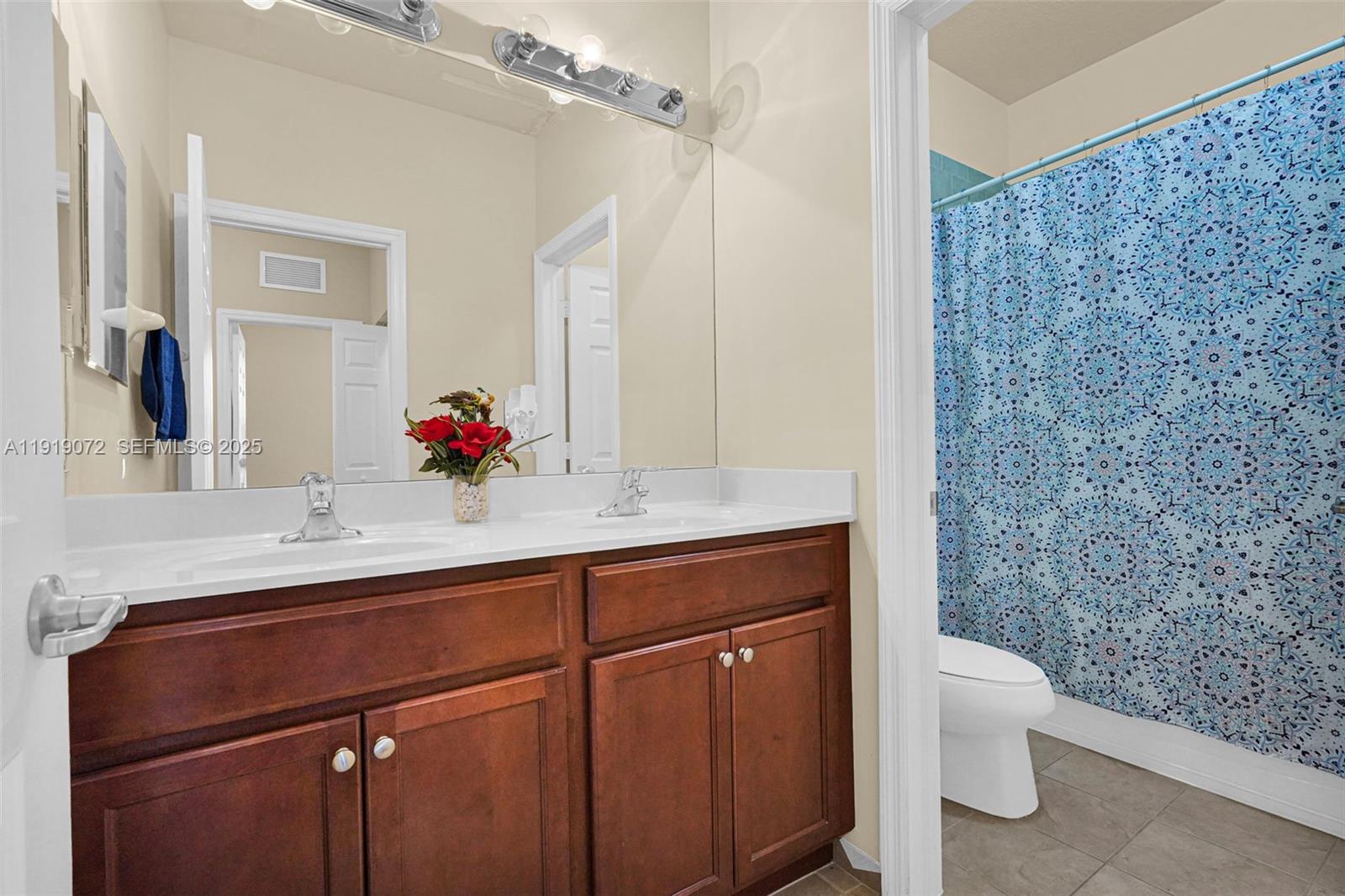 9213 Southwest 170th Avenue Miami, FL 33196 - Photo 54 of 82 a bathroom with a sink a toilet and shower