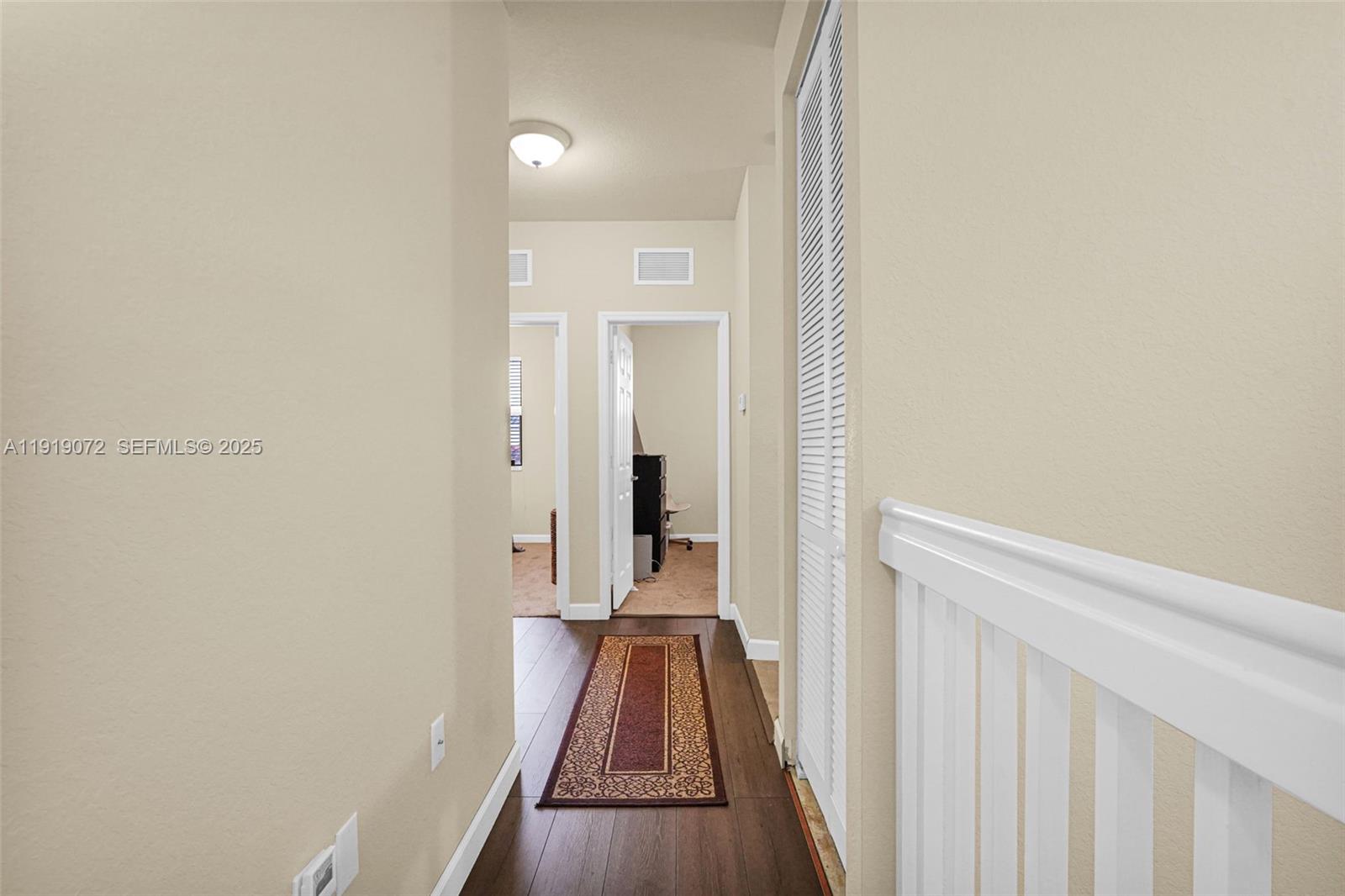 9213 Southwest 170th Avenue Miami, FL 33196 - Photo 55 of 82 a view of a room with wooden floor and a hallway