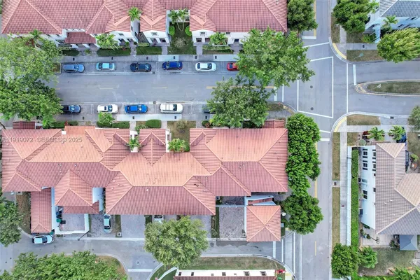 a front view of a house with a yard and a garden