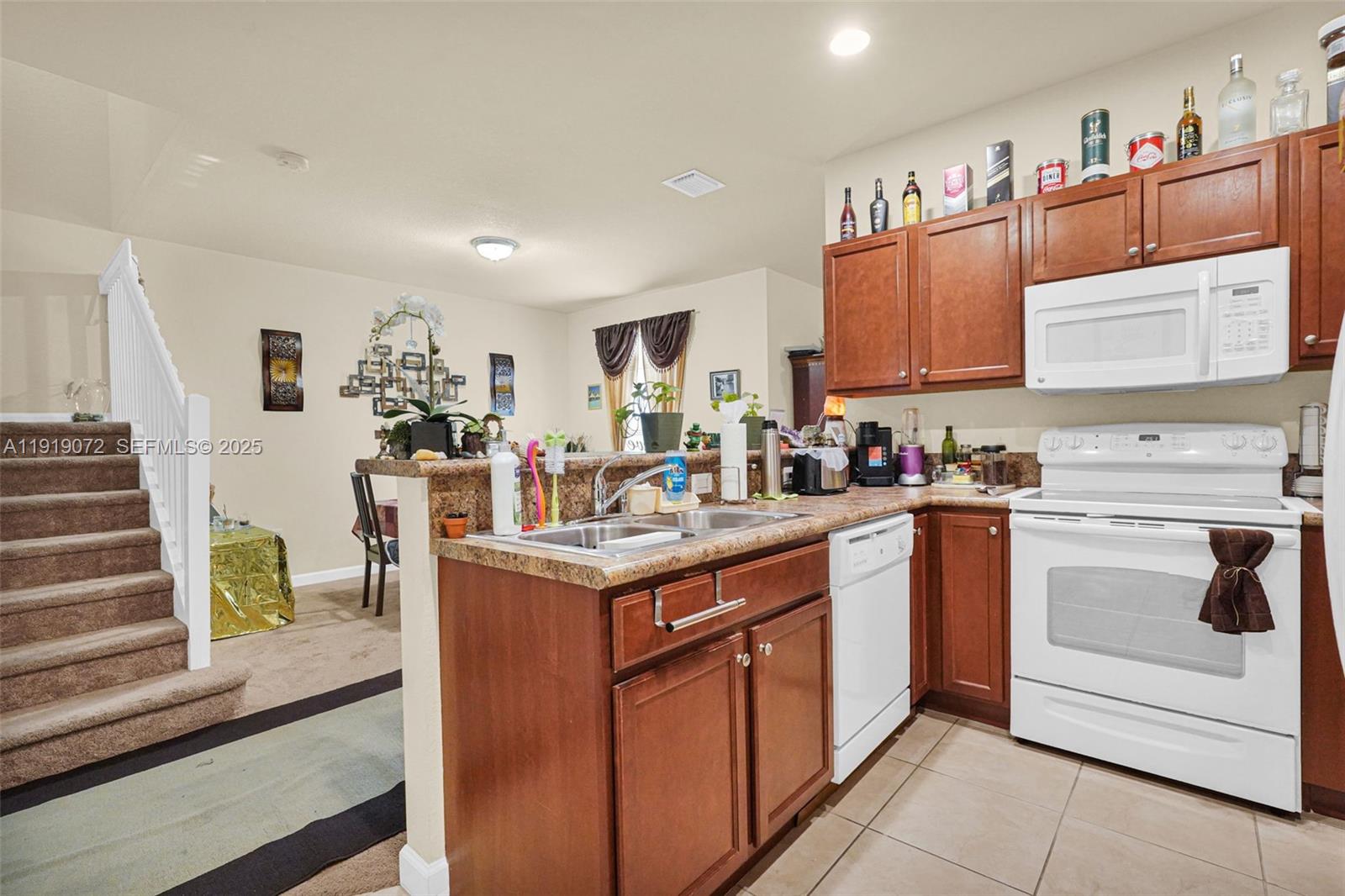9213 Southwest 170th Avenue Miami, FL 33196 - Photo 80 of 82 a kitchen with stainless steel appliances granite countertop a stove and a sink