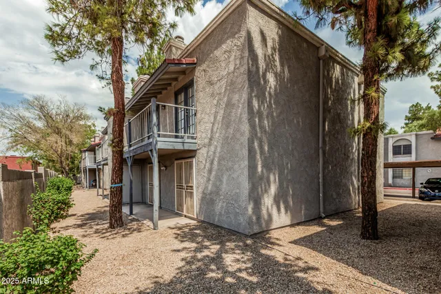 a view of a house with a large tree