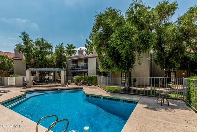 a swimming pool with outdoor seating and yard