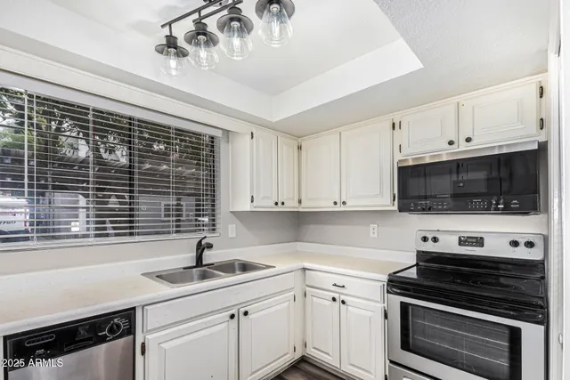 a kitchen with a sink stove and cabinets