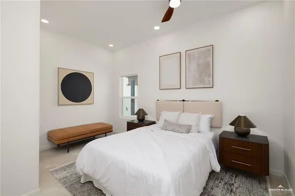 a bedroom with a bed and a large mirror