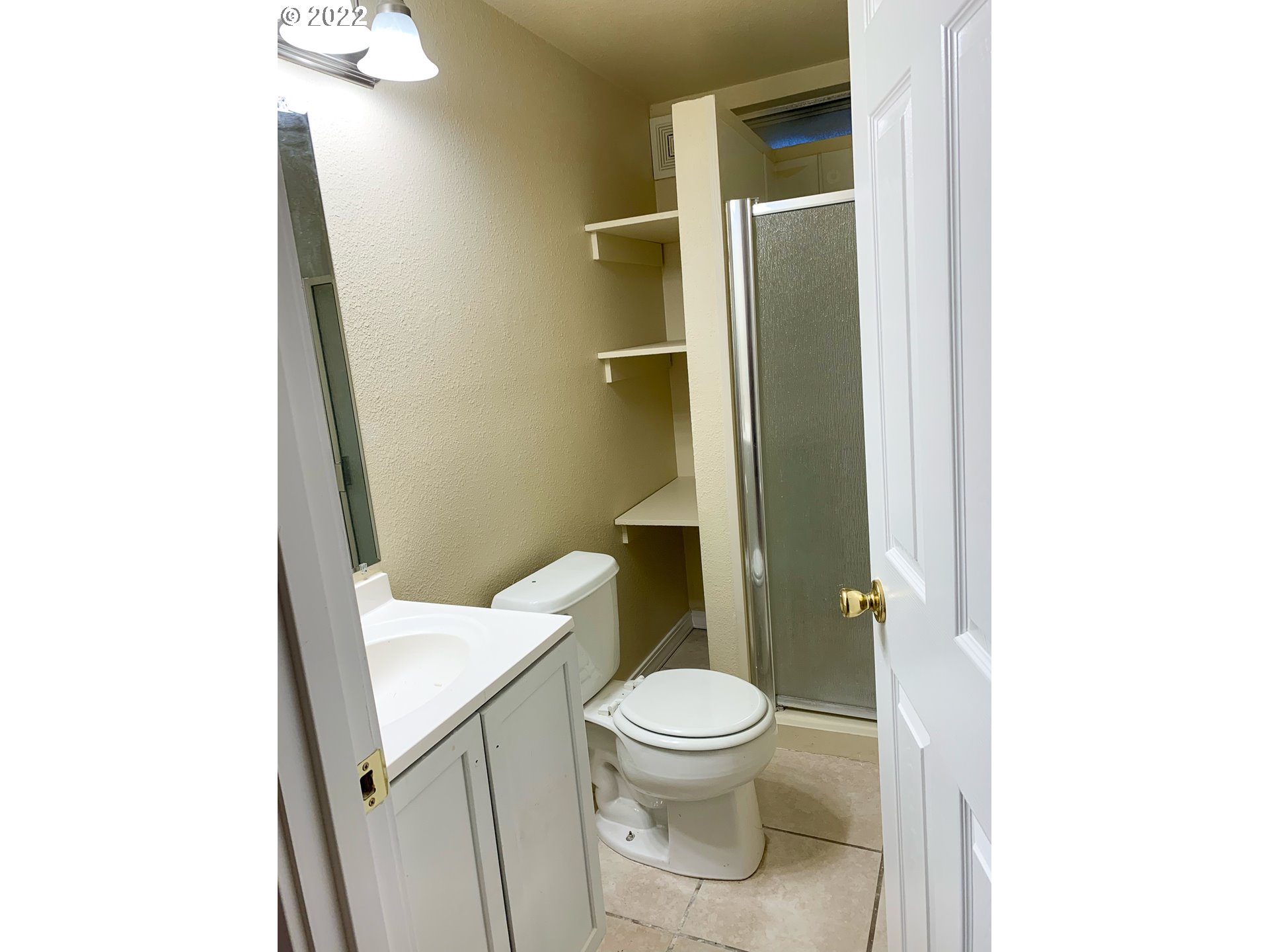 205 57th Street Springfield, OR 97478 - Photo 10 of 13 a white toilet sitting next to a bathroom sink