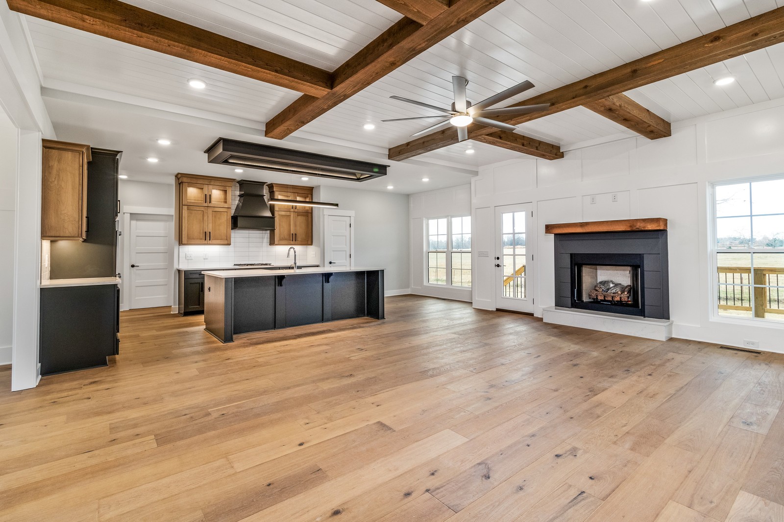 24 Port Royal Estate Adams, TN 37010 - Photo 8 of 34 an empty room with wooden floor fireplace and windows