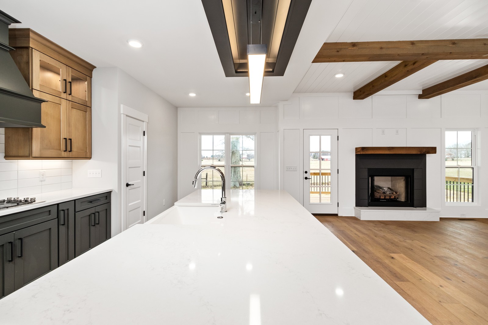 24 Port Royal Estate Adams, TN 37010 - Photo 10 of 34 a large white kitchen with granite countertop a stove a sink a dining table and chairs with wooden floor