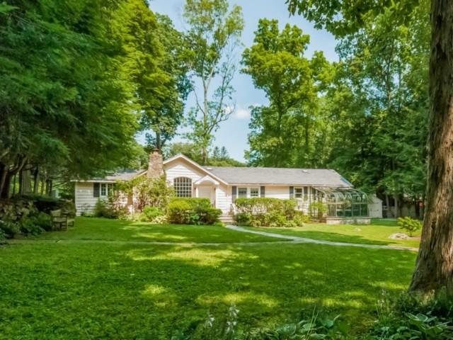 a front view of house with yard and green space