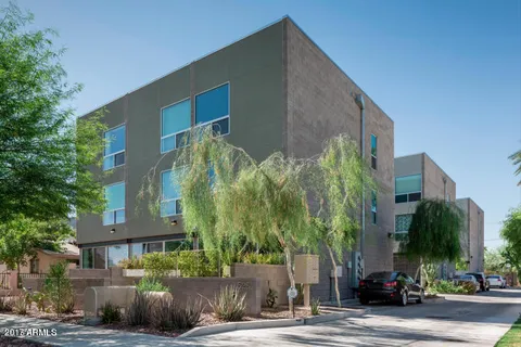 a couple of cars parked in front of a house