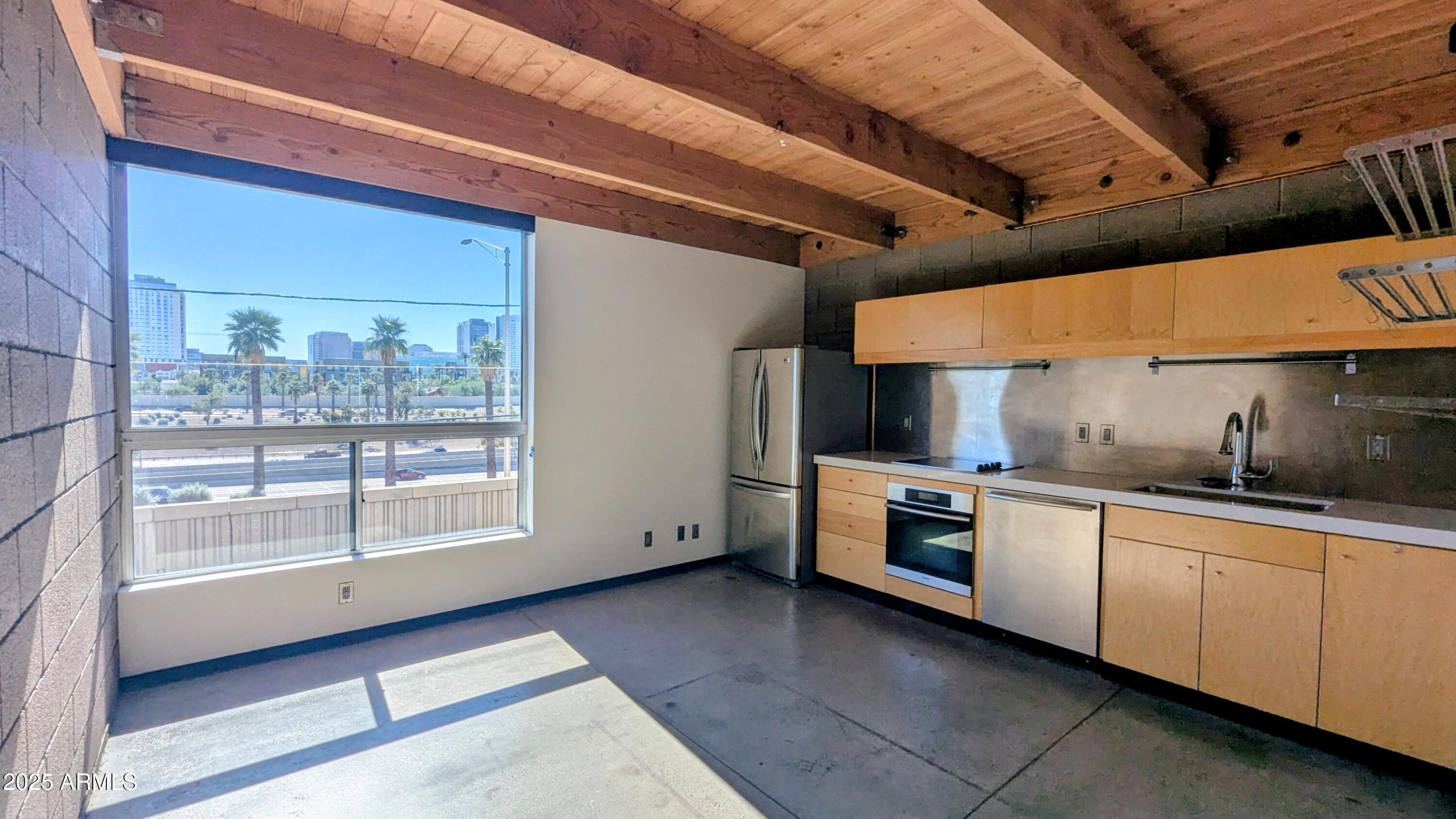 525 East Willetta Street, Unit 8 Phoenix, AZ 85004 - Photo 14 of 25 a kitchen with stainless steel appliances granite countertop a stove and a sink