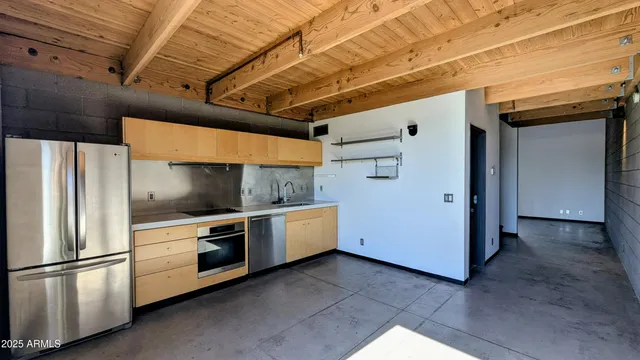 a kitchen with stainless steel appliances a refrigerator and a stove