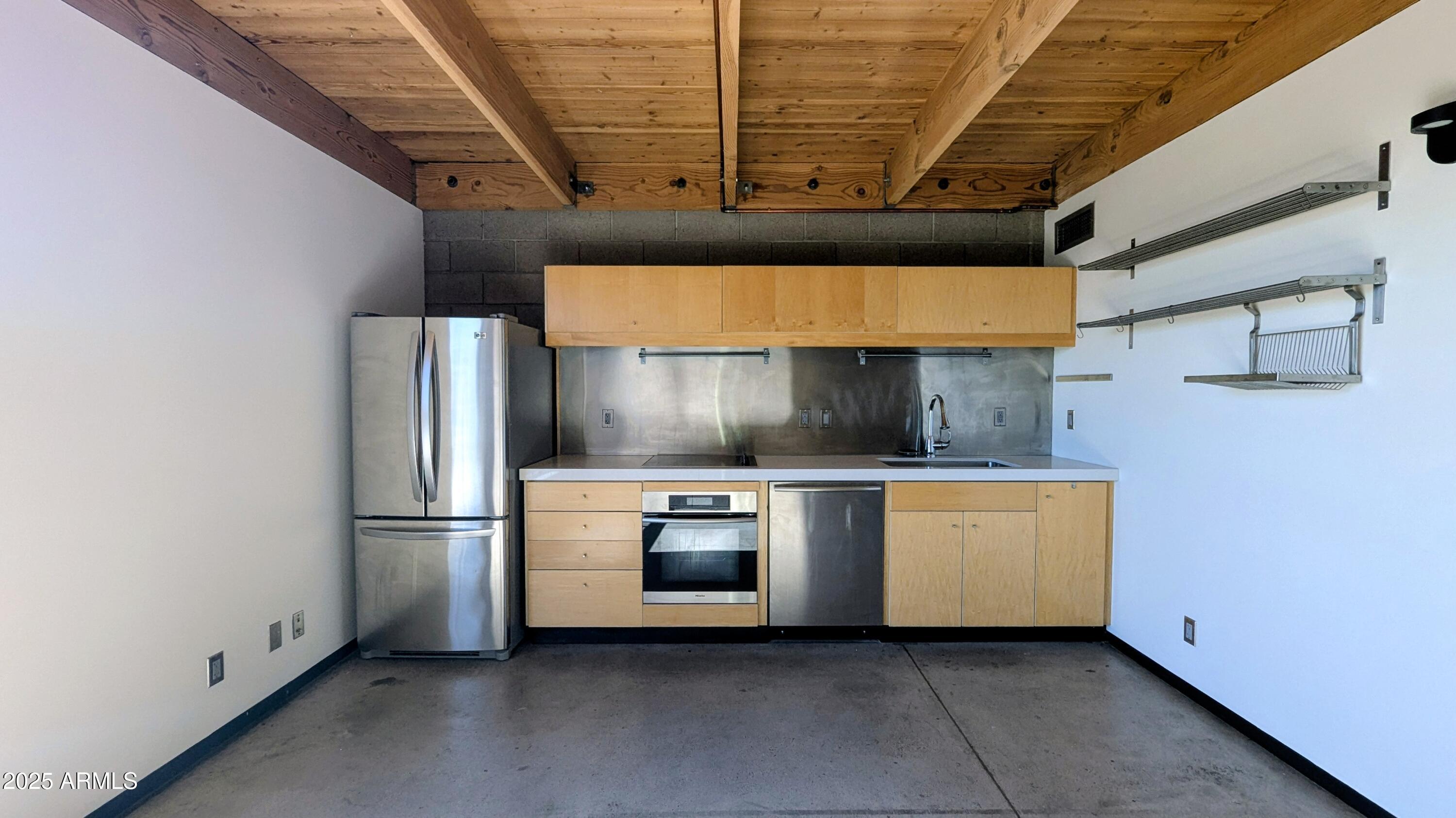 525 East Willetta Street, Unit 8 Phoenix, AZ 85004 - Photo 17 of 25 a kitchen with stainless steel appliances a refrigerator and a stove